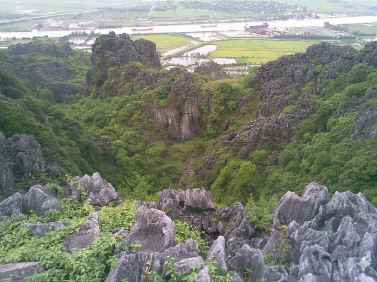 Admire the lush green rice fields from the summit of Voi An Lao Mountain.